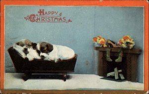 Christmas Cute Puppy Dogs Sleep in Wooden Cradle Fireplace c1900s-20s Postcard