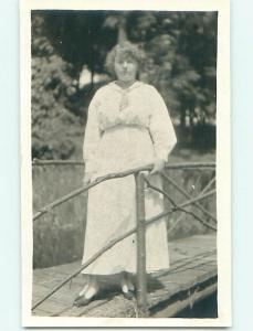 Pre-1930 rppc WOMAN ON BRIDGE WITH RAILINGS MADE OF BRANCHES r6185