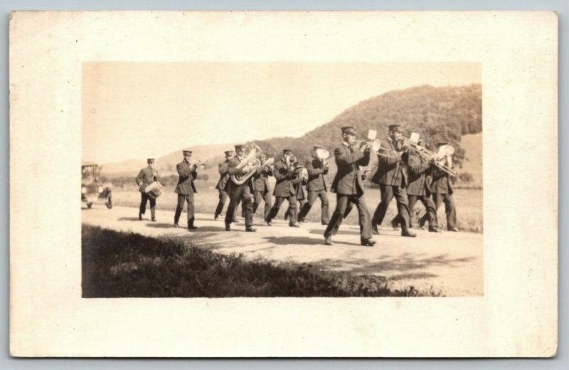 RPPC Marching Band on Elevated Rd in Hilly Region~Trombones Lead~Tuba~Drum~c1914 