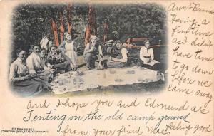 Group of men and woman sitting around picnic blanket antique pc Z42452