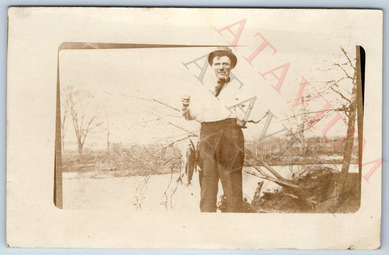 c1910s Cool Man Fish Catch RPPC Fisherman Smokes Pipe Outdoors Nature Photo A174
