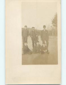 Pre-1910 rppc BOYS SITTING AND MAN STANDING ON FROZEN ICE HM0740