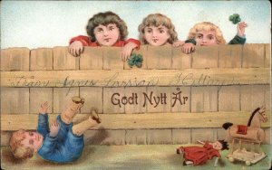 New Year Godt Nytt Ar Boy Falls Over Fence Toy Horse Doll c1910 Vintage Postcard