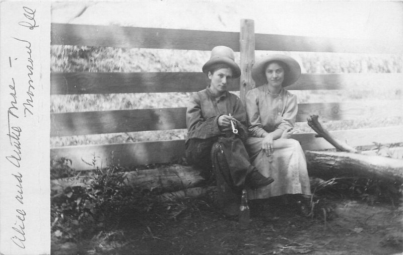 Woman Dressed In Pants & Shirt Holding A Smoking Pipe. Real Photo Postcard