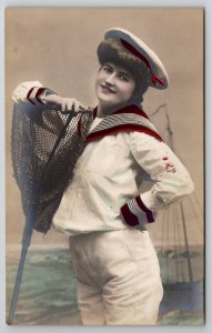 RPPC Lovely Lady Sailor with Net Seascape Studio Backdrop Tinted Postcard L36