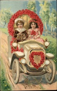 Birthday Romance Little Boy and Girl Driving Car c1910 Gel Vintage Postcard