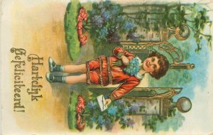 Early greetings postcard girl with envelope flower bouquet