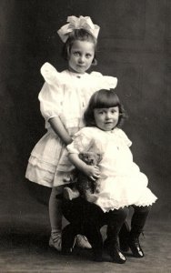 c1910 2 YOUNG GIRLS TEDDY BEAR FANCY DRESSES BIG BOW RPPC POSTCARD P161