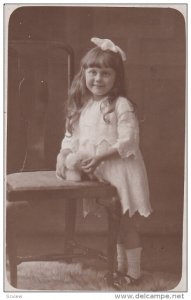 RP, Beautiful Little Girl Beside A Chair & Holding A White Toy Puppy, 1920-1940s