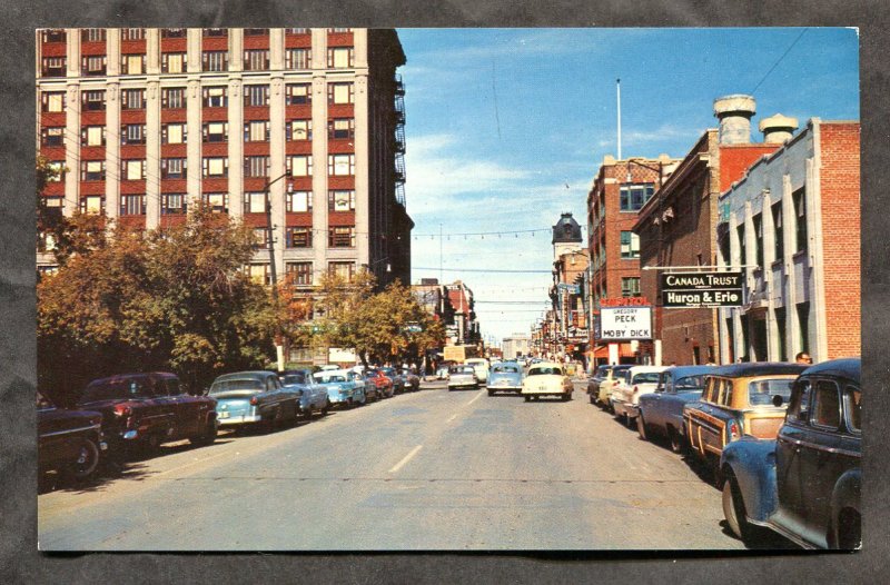 5287 - REGINA Sask 1950s Street View. Woody Wagon, Cars. Movie Theater Moby Dick