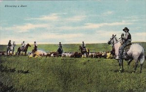 Cowboys On Horseback Throwing A Steer