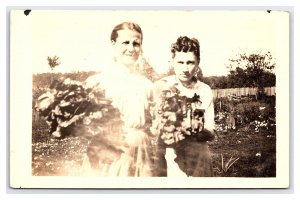 Two Women Holding Produce From The Garden Real Photo Postcard RPPC