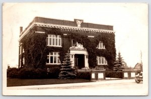 Denmark WI~Eagle Over Ivy Covered State Bank~Blue Pine Trees~RPPC 1930 Postcard 