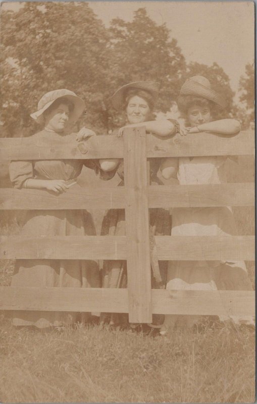 RPPC Postcard Woman Behind Fence Wearing Summer Hats 1908