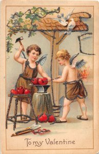 J58/ Valentine's Day Love Holiday Postcard c1910 Cupid Blacksmith 152