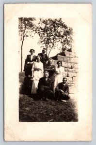 RPPC Group of Men & Women Pose by Stone Wall AZO 1904-1918 ANTIQUE Postcard 1330