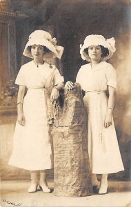 Two young ladies in dresses and hats Adults & Children Writing on Back 