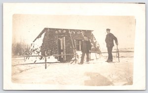 UK Rugged Tall Young Chap~Smaller Gent by Gate~Turf/Sod Hut~Snowy Day Hats RPPC