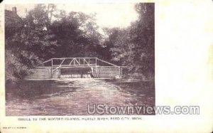 Bridge to the wooded island, Hersey River in Reed City, Michigan