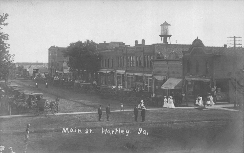 Real Photo Postcard People and Automobiles Main Street in Hartley, Iowa~113450 