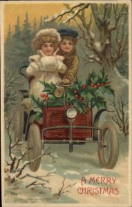 Christmas Fancy Girls Drive Car Holly Muff Embossed c1900s-20s Postcard