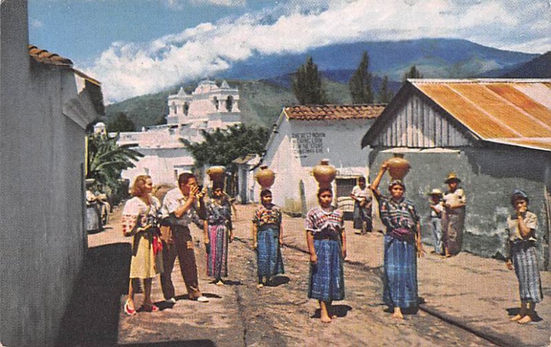 Guatemalan Women carrying water home in large earthen jugs Guatemala, Central...
