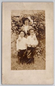 RPPC Mother Big Hat with Two Sons on Grass  Postcard F25