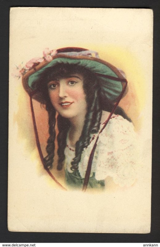 Woman smiling showing overbite of teeth, dark hair ringlets fancy floral hat