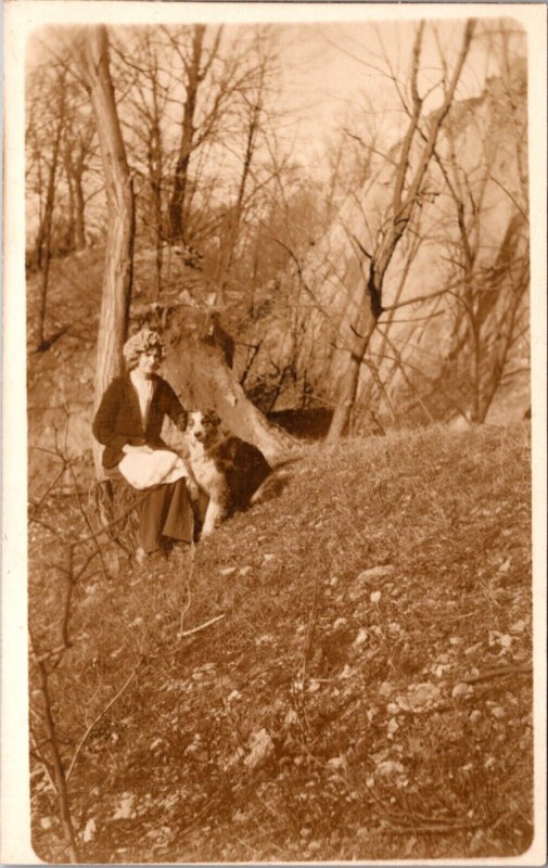 Real Photo Postcard Woman and Dog Sitting on a Tree Stump in the Woods