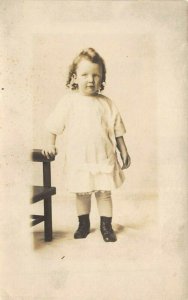 1910s RPPC Real Photo Postcard Young Girl Toddler Dress Standing By Chair