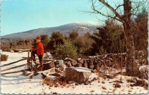 Man in red hat and coat reminiscing in New England Winter Scenic postcard