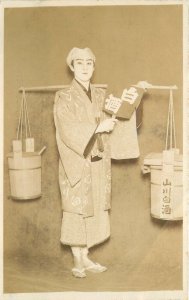 Postcard RPPC Japan C-1910 Native man dressed shoulder bucket 23-10996