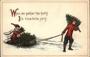 Christmas Romance Boy and Girl Gather Holly Sled Sledding c1910 Postcard