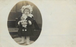 UDB RPPC Postcard Cute Little Dressed-up Girl Holds her Prized Doll, Unposted