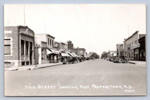 J90/ Cooperstown North Dakota RPPC Postcard c1950s Main Street Stores 652