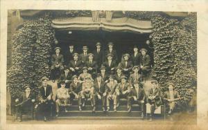 c1910 College Fraternity Men Group Photo Patriotic Flags Ivy Arch RPPC Postcard