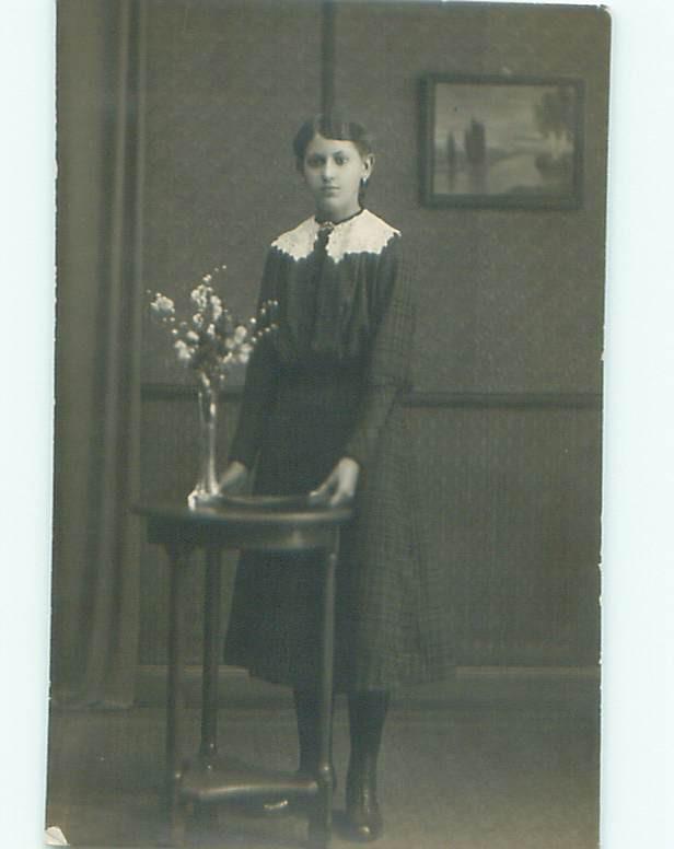 rppc 1920's GIRL STANDING AT ANTIQUE WOODEN STAND AC8548