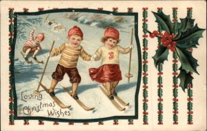 CHRISTMAS Cute Kids Skiing Skiers Holly Border c1910 Postcard