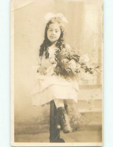 Pre-1930 rppc PRETTY GIRL WITH BOW IN HAIR SITTING ON PEDESTAL o2070