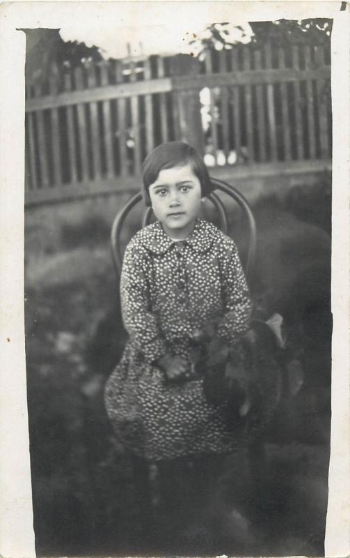 Vintage children topic photo postcard cute girl sitting on a chair