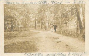 Oswego New York Couple walking in the woods c-1910 RPPC Postcard 25-11215