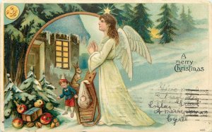 Embossed Christmas Postcard 432 Angel Brings Toys, Goodies to House in Forest