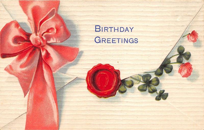 Birthday Greetings~Large Ribbon on Envelope~Seal~Clovers Stick Out~1909 Embossed