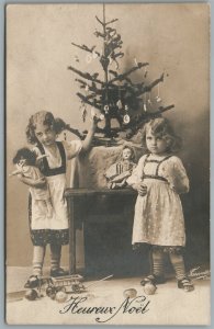SISTERS w/ DOLLS UNDER DECORATED CHRISTMAS TREE ANTIQUE REAL PHOTO POSTCARD RPPC