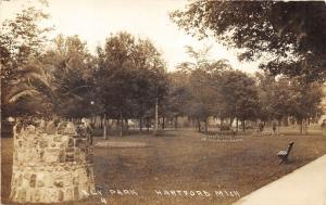 Hartford Michigan~Ely Park Scene~Old Man Watering Flower Garden~c1920 RPPC