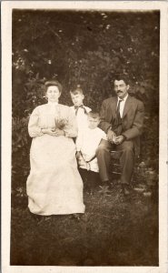 Edwardian Family Photo Mother Father Two Sons Rustic Wooded Scene Postcard Z14