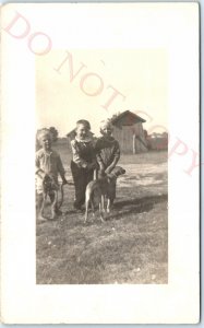 c1920s Cute Dog Handsome Little Boys RPPC Outdoors Play Farm Outhouse Photo A142