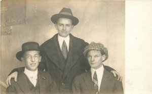 C-1910 2 Young men hats Fashion pin back interior RPPC Photo Postcard 22-9733