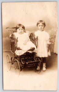 Two Young Children Girls Old Wicker Stroller Portrait RPPC Postcard Real Photo