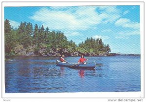 Exploring along the rock fringed shoreline, Minnesota, 40-60s